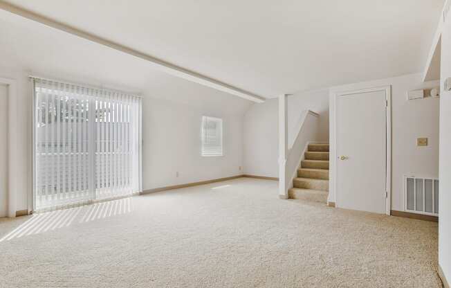 renovated living room with carpet and stairs
