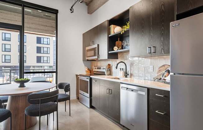 A modern kitchen with a large island and stainless steel appliances.