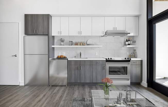 Kitchen with stainless steel appliances and white cabinets at Edendale Crossing, Echo Park, Los Angeles