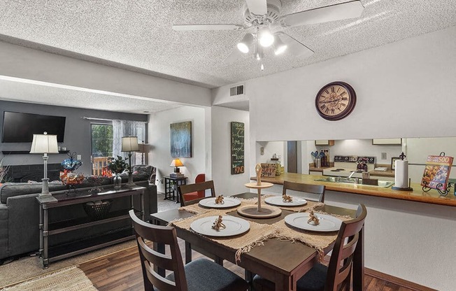 a dining room table with chairs in a living room