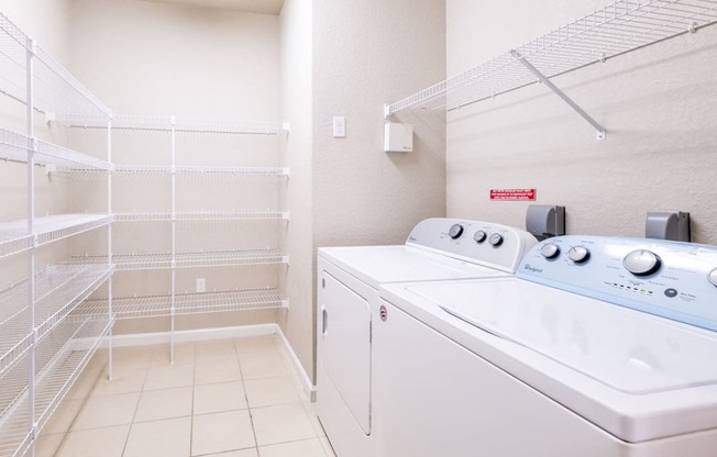 a washer and dryer in a laundry room with a closet