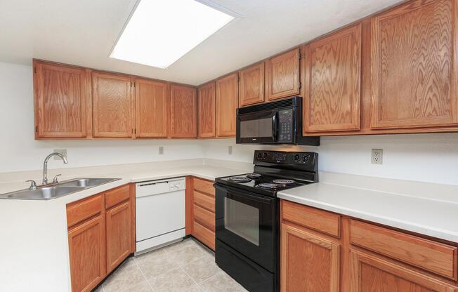 a kitchen with stainless steel appliances and wooden cabinets