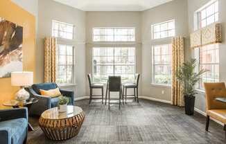 a living room and dining room with a table and chairs