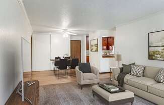 a living room with a couch and a chair and a dining room at Pheasant Park Apartments, Minnesota, 55428-5401