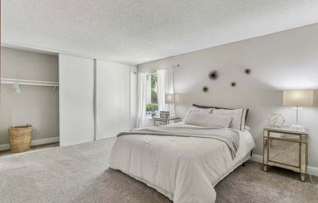 a master bedroom with a bed and a closet at Summerwood Apartments, Santa Clara, 95050