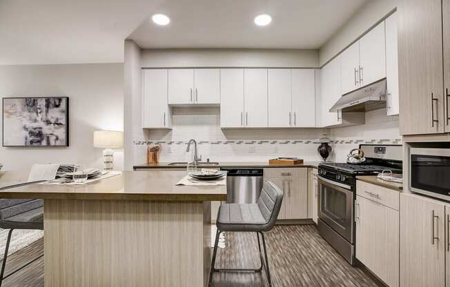 a kitchen with an island and a stove and a sink