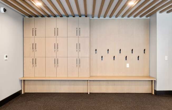 a row of white lockers in a room with a brown carpet