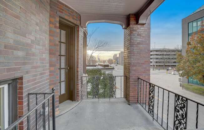 a balcony with a view of a city and a door to a balcony