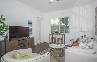 a living room filled with furniture and a large window
