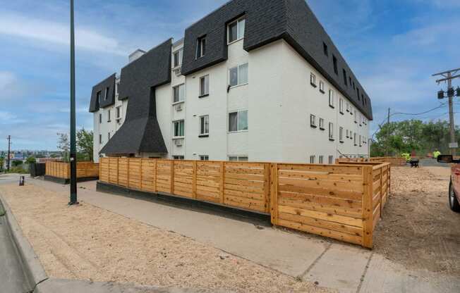 a wooden fence in front of an apartment building