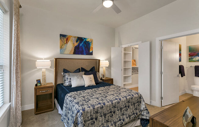 a bedroom with a bed and a ceiling fan at Aster Apartments, Beachwood