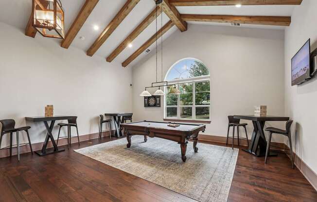 An entertainment room with a pool table  at Creekside on Parmer Lane Apartments in Austin, TX