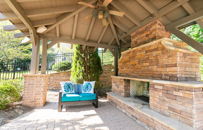 a patio with a bench and a gazebo