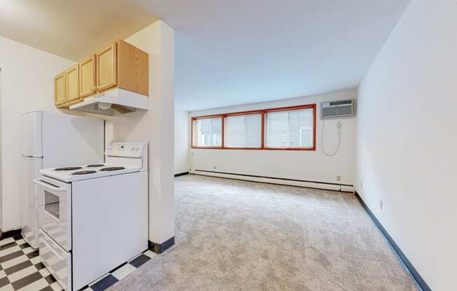 a kitchen with white appliances and a black and white checkered floor