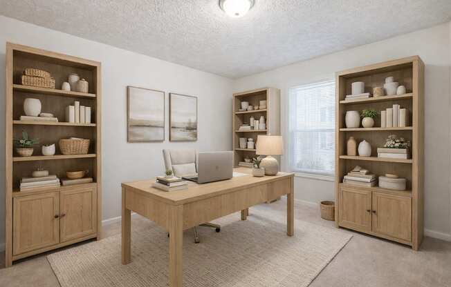 A room with a desk, chairs, and shelves filled with various items.