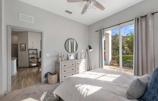 a bedroom with a bed and a ceiling fan