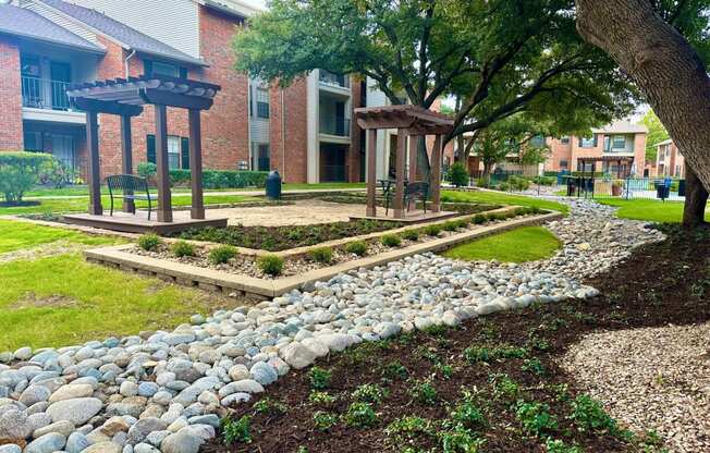 a garden with rocks and a stone path