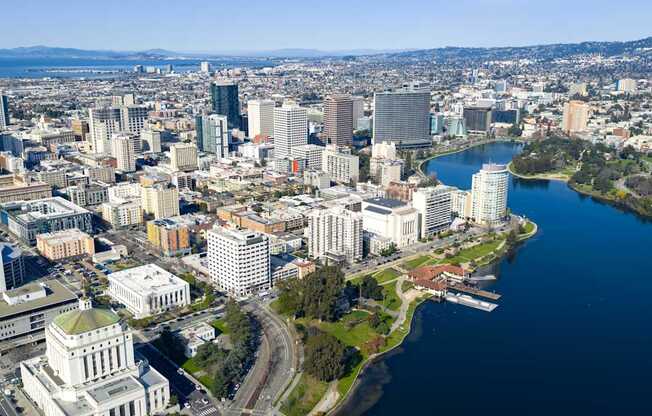 A cityscape with a large body of water in the foreground.