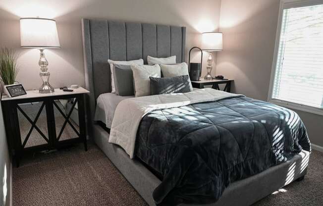 a bedroom with a bed and two nightstands