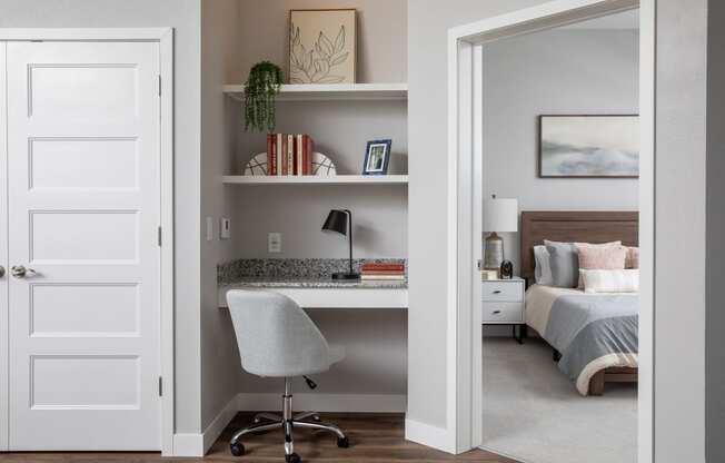 a bedroom with a desk with a chair and a bed at The Edison at Maple Grove, Maple Grove