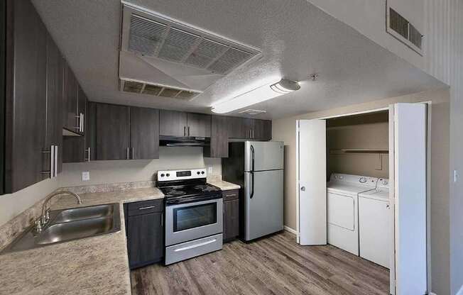 A kitchen with a stove, oven, refrigerator, and dishwasher.