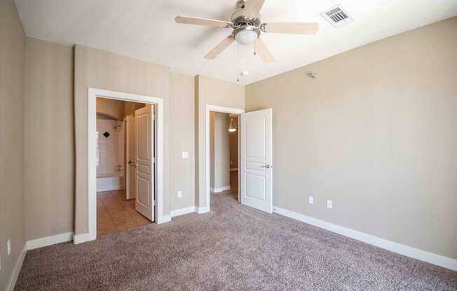 a bedroom with a ceiling fan At Metropolitan Apartments in Little Rock, AR