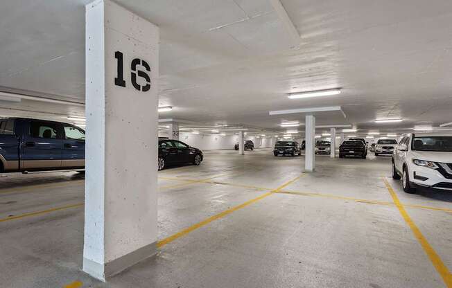 A parking garage with the number 16 on a pillar.