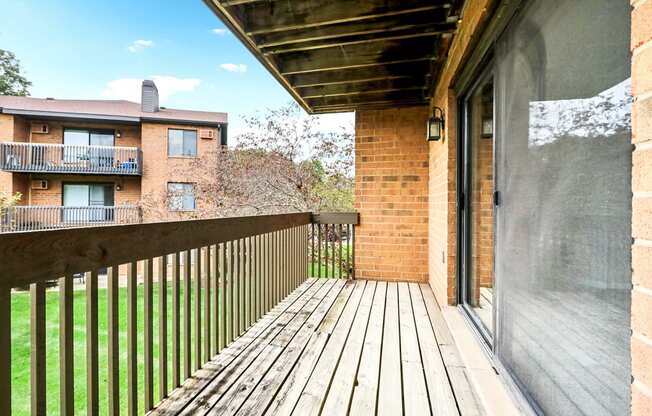 the view from the deck of a balcony with a wooden railing