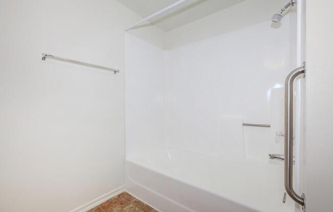 a white tub sitting next to a shower