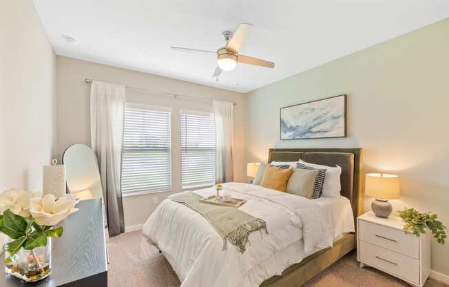 a bedroom with a large bed and a ceiling fan