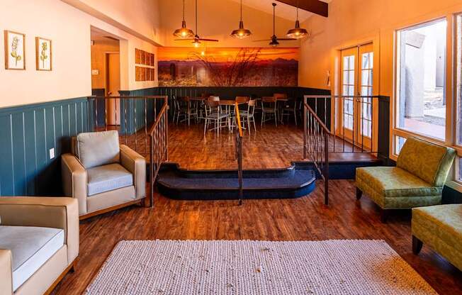 A living room with a sofa, chairs, and a rug.