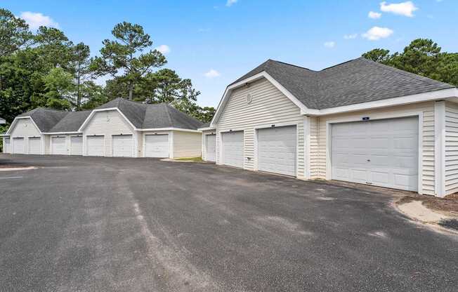 A row of garages with a clear blue sky above.