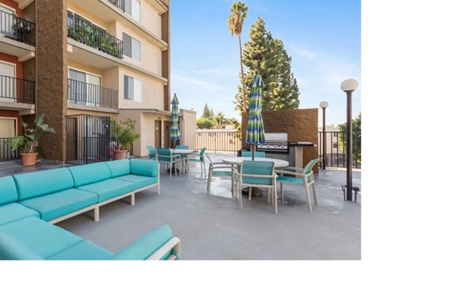 a rendering of a patio with blue couches and tables