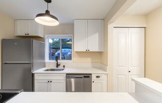 The Reserve at Bucklin Hill Apartments  kitchen with white cabinets and a stainless steel refrigerator