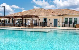 The pool and exterior clubhouse at the Flats at Sundown in North Port, Florida