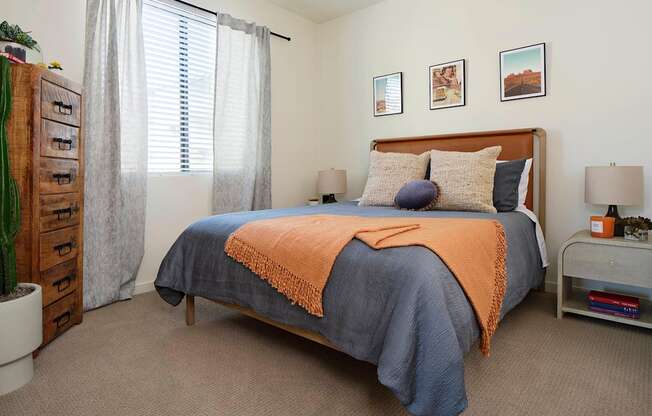 a bedroom with a bed and a dresser