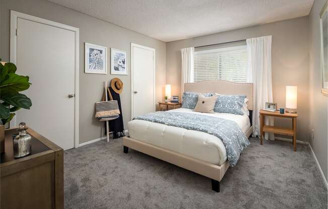 a bedroom with a bed and two nightstands