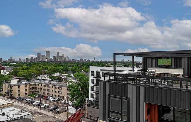 A modern building with a balcony overlooking a cityscape.