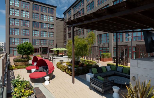 a rendering of a rooftop patio with couches and chairs