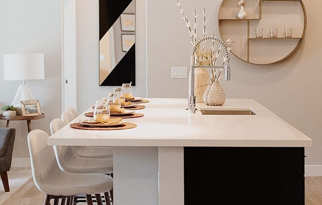 a dining room with a table and chairs and a mirror