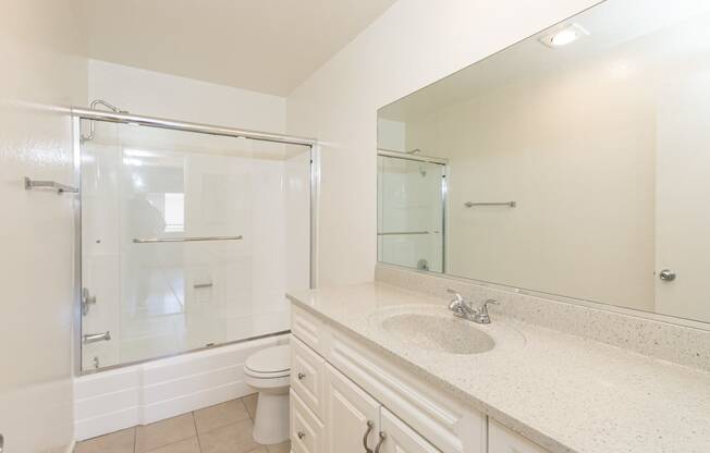 Bathroom with White Cabinets and Bathtub/Shower