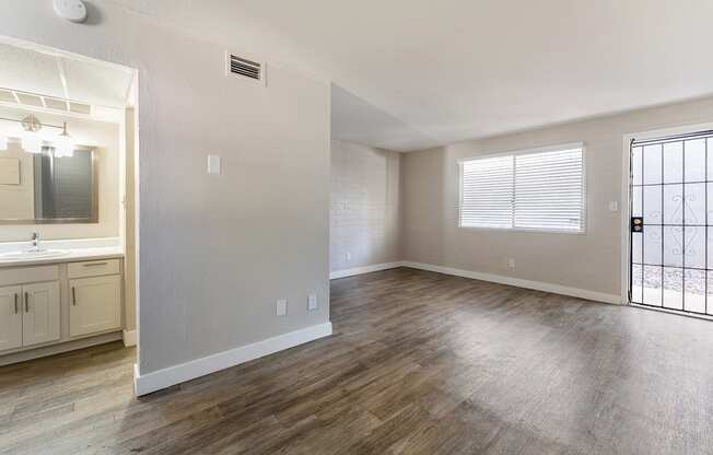Bathroom Vanity and living room at Avani North Tucson Apartments in Tucson Arizona