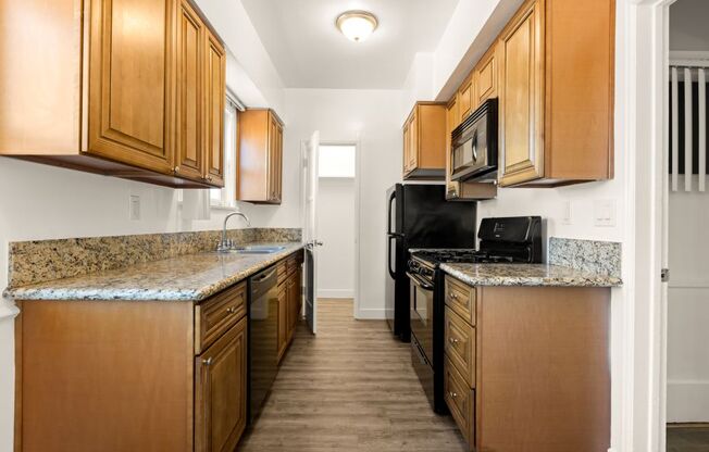 a kitchen with wood cabinets and granite counter tops