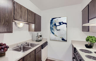 a kitchen with wooden cabinets and a sink