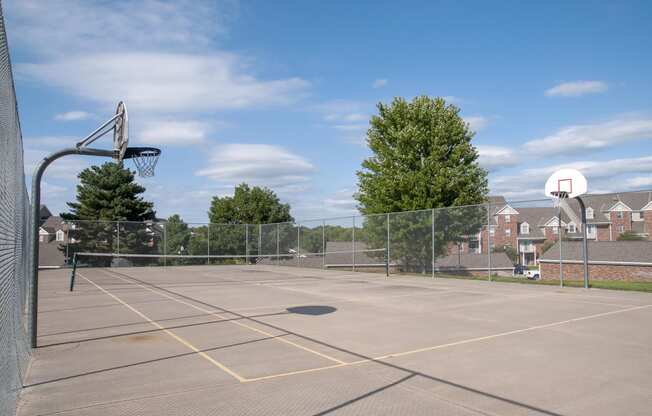 Outdoor Fenced Basketball Court with Two Hoops