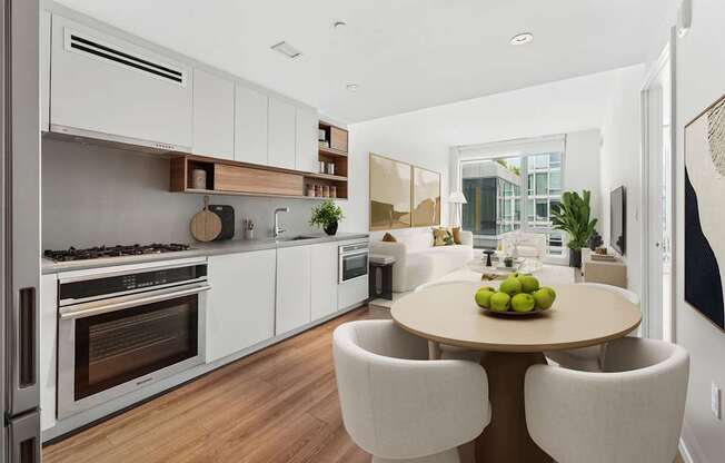 A modern kitchen with a dining table and chairs.