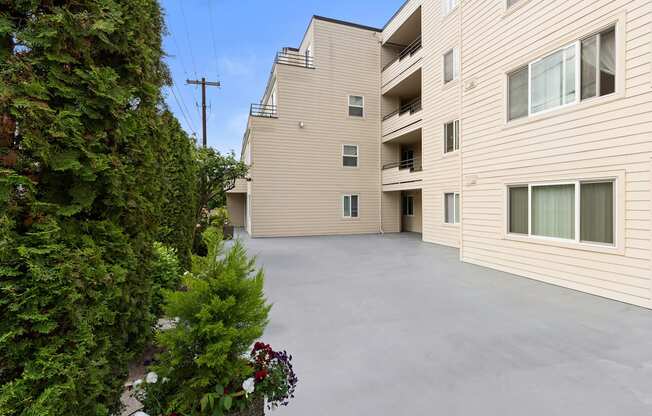 Outdoor Deck Area with Potted Flowers and smooth paving at Hill Crest Apartment Homes, Washington, 98126