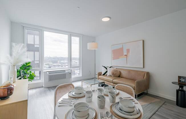 a living room with a table and a couch and a window