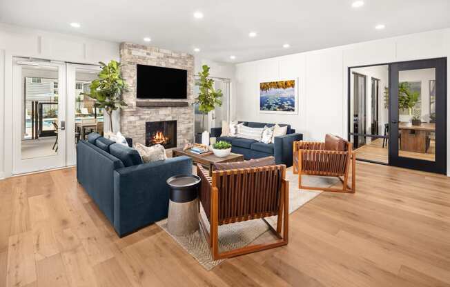 Lounge Area with Blue Couches, Fireplace, and Wooden Chairs at Solstice at Fiddyment Ranch, California