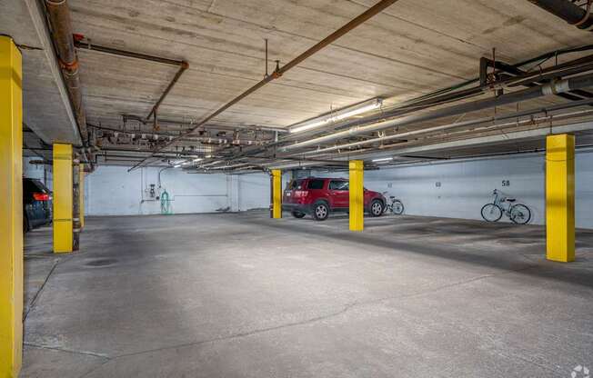 an empty parking garage with cars and bikes in it